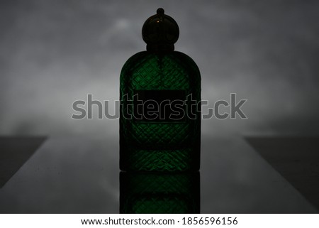 Parfume luxe bottle on dark background, silhouette bottle