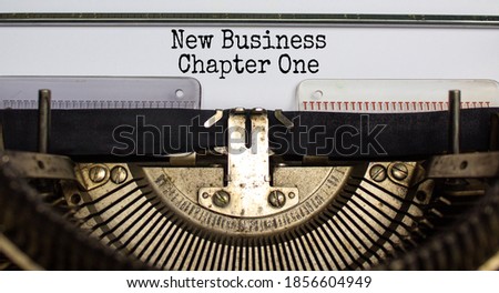 Text 'new business, chapter one' typed on retro typewriter. Business concept. Beautiful background.