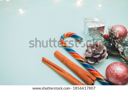 New year and Christmas concept holiday decorations Flatlay template top view holiday Christmas background with copy space on blue background. Greeting card template. Selective focus.