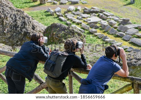 Three tourists with virtual reality mask while visiting the city of Rome in Italy - Circus Maximus
