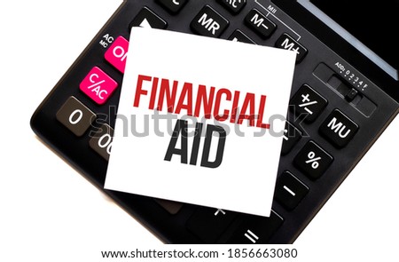 calculator with text financial aid with white paper
