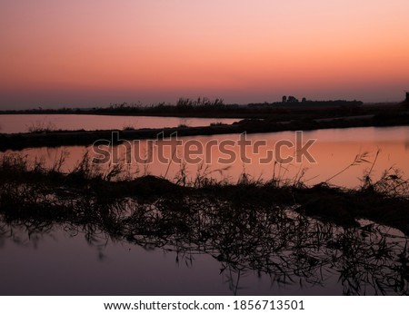 Landscape with sunset, dusk with orange reflections of sunset