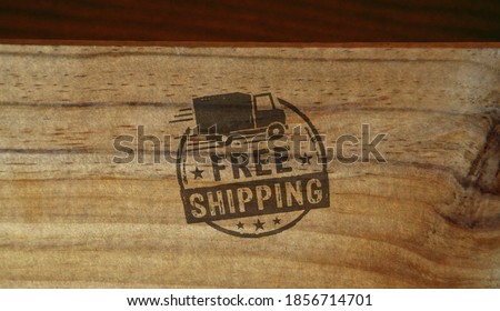 Free shipping stamp printed on wooden box. Gratis delivery, service and package transport concept.