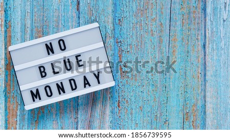 Blue monday day banner concept. White board with text no blue monday on blue wooden background, top view, flat lay. Copy space
