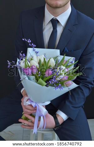 bouquet in the hands of a man