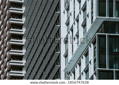 Repetition patterns in facades of buildings covered by glass, aluminium frames and structured with concrete columns
