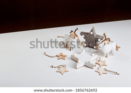 New Year or Christmas composition. Light box inscription Merry Xmas and wooden ornaments, copy space.