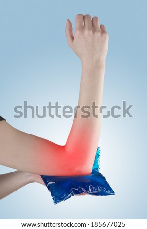 Woman holding ice gel pack on elbow. Medical concept photo. 