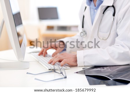 View of Details of doctor hands typing on keyboard Royalty-Free Stock Photo #185679992