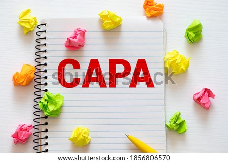 Paper with words CAPA Corrective and Preventive action plans.