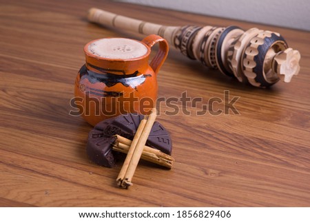 Hot Mexican cocoa beverage with ingredients and molinillo Royalty-Free Stock Photo #1856829406