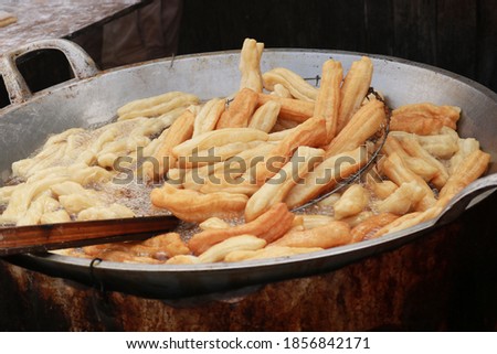 Youtiao is a long golden-brown deep-fried strip of dough commonly eaten in China and (by a variety of other names) in other East and Southeast Asian cuisines. In indonesia, they are called cakwe.