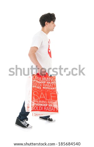 Young man is agitated by the sale with many bags