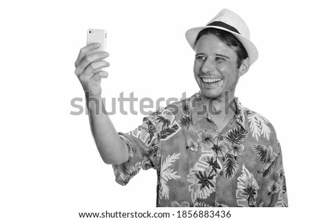 Happy Caucasian man taking selfie with mobile phone ready for vacation