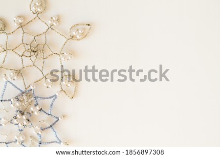 Snowflakes made of beads on a white background. Christmas background. Christmas mood.
