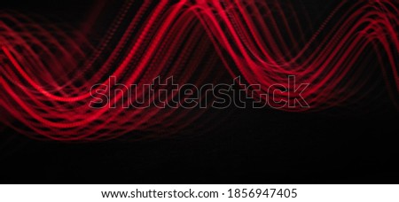 Neon light waves pattern abstract in a black background