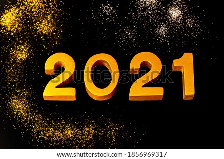 2021 made of wood and  gold painted on black background,placed on the backdrop,concept to gold glitter powder sparkling as same as fireworks