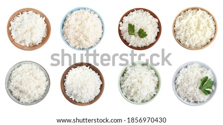 Set of bowls with cooked rice isolated on white, top view. Banner design Royalty-Free Stock Photo #1856970430