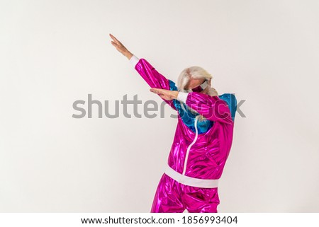 Senior man with eccentric look  - 60 years old man having fun, portrait on colored background, concepts about youthful senior people and lifestyle