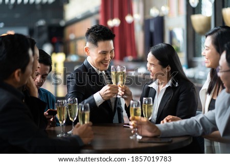 Group Of Asian Friends Enjoying Evening Drinks in bar. Celebration, Party People Christmas and Happy new year concept. Asian business people in party.
