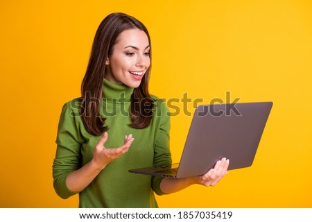 Photo of attractive lady hold notebook video call talk communicating wear green sweater isolated yellow color background