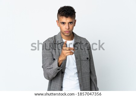 Young brazilian man isolated on white background frustrated and pointing to the front