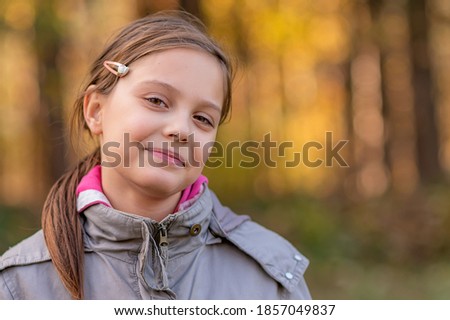 Portrait of a girl in the woods with a beautiful bokeh. 