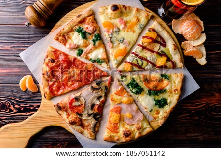 different pizza slices on a wooden table, mix of eight different pizzas on a wooden background. menu concept of choice and diversity
