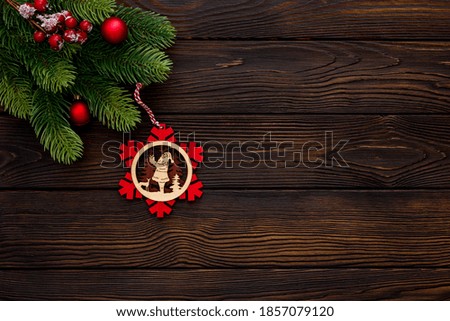 Spruce branch, cones and vintage toys decoration on christmas or new year on dark wooden background

