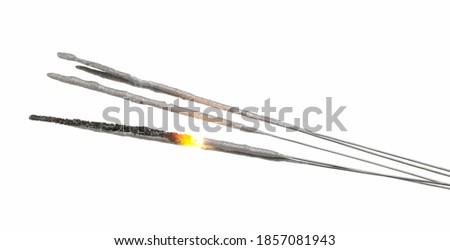 Sparklers burning and emitting flame, New Year's celebration pyrotechnic fireworks, isolated on white background with clipping path