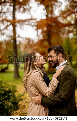 Handsome young couple walking in the autumn park