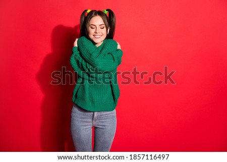 Photo of young beautiful smiling cheerful positive female hug embrace herself isolated on red color background