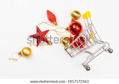 supermarket trolley with Christmas decorations on a white background. Flat lay, top view.