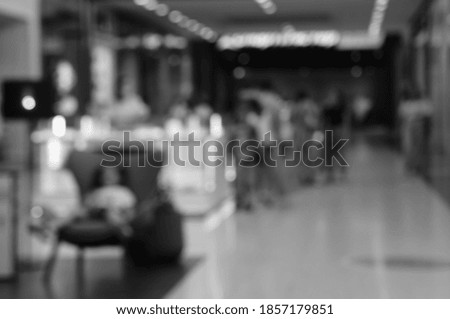Blurry background. Shopping center gallery with people.