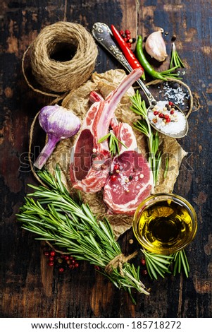 Raw lamb cutlets with vegetables, herbs and spices Royalty-Free Stock Photo #185718272