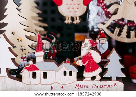 Colorful wooden Christmas decoration with Santa Claus and fir tree