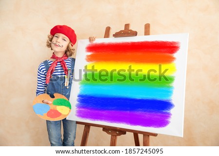 Artist child painting the picture on canvas. Happy kid pretend to be painter. Imagination and childhood dream concept