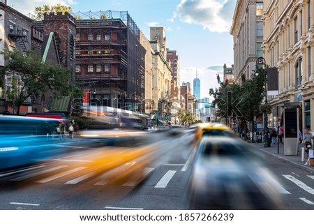 Busy street scene with cars, taxis and buses driving up 6th Avenue through Manhattan in New York City NYC