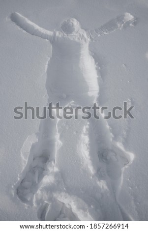 Human body print on fresh snow. imprint of a man in the snow. the end of the winter holidays