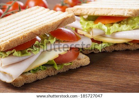 delicious sandwiches with chicken breast, salad, cheese and tomatoes