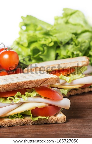 Sandwiches with chicken breast, salad, cheese and tomatoes