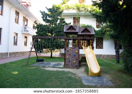 A colorful playground in the yard in the park.
