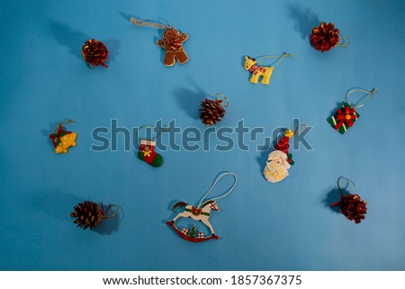 Celebration, party background concept for winter party - decorative toy ornaments on light blue background. Christmas and New Year decoration