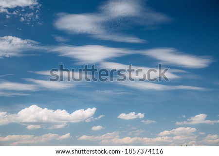 Perfect blue sky with white fluffy clouds in sunny day. Template image textured sky background. Climate change, ecology concept. Photo of summertime. Picturesque natural wallpaper. Beauty of earth.