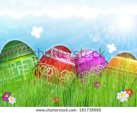 Colorful Easter eggs on meadow with spring flowers