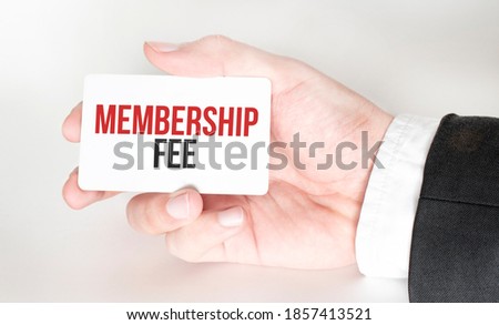 businessman holding a card with text MEMBERSHIP FEE