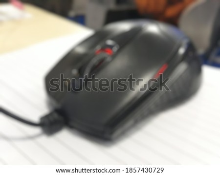 Blurred mouse above piece of paper