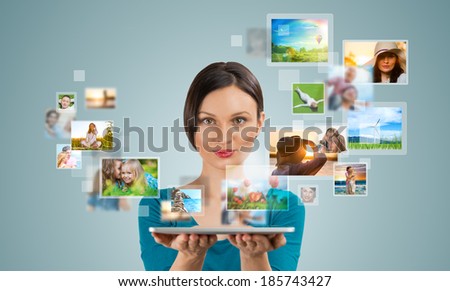 Portrait of young happy woman sharing her photo and video files in social media resources using her modern tablet computer