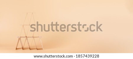 House of cards on long beige background with copy space