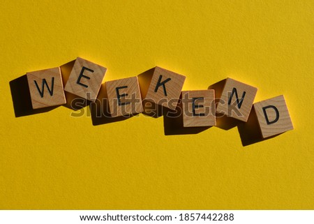 Weekend, word in wooden alphabet letters isolated on bright yellow background